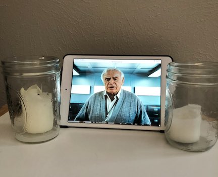 Shrine consisting of two candles and a picture of Ernest Borgnine from the film RED